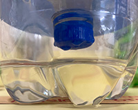  A blue filter on top clear water in a bottle